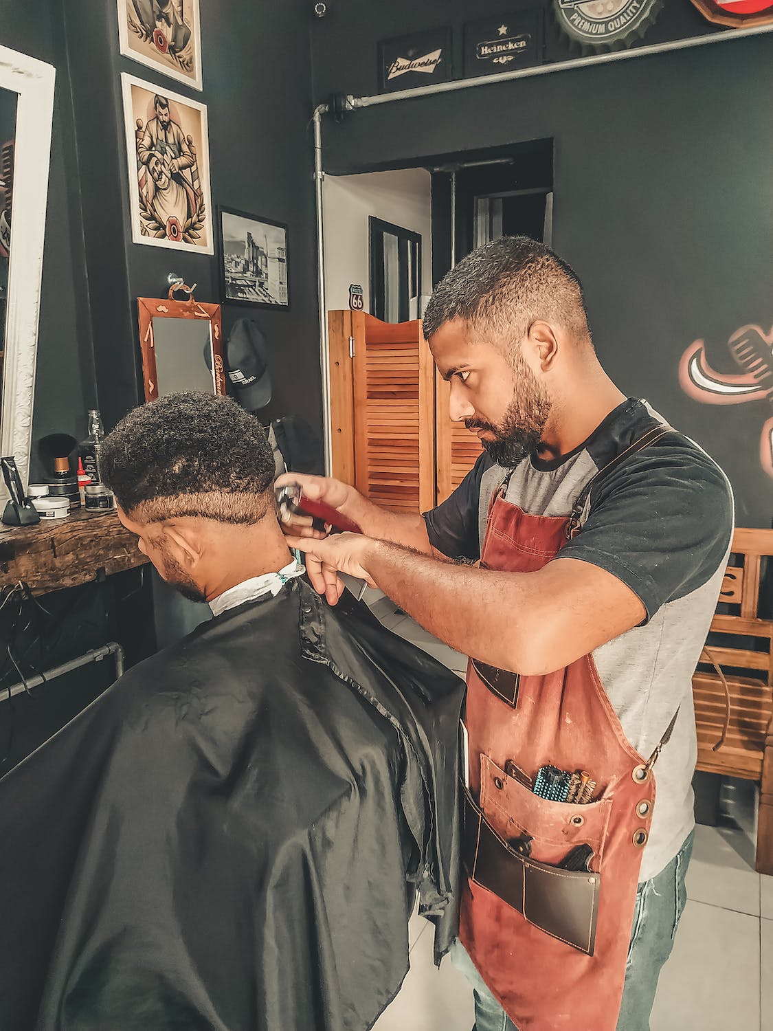 Barber cutting fade on the back of his customers head near his neck